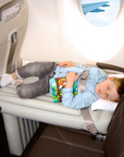 Toddler sleeping on the plane on the inflatable airplane bed Flyaway Kids Bed