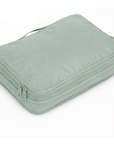 Light green travel packing cube on a white background