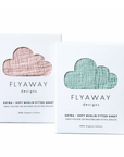 Two boxes of Flyaway Designs muslin fitted sheets, one pink and one green, on a white background.