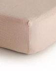 Corner of blush pink fitted sheet