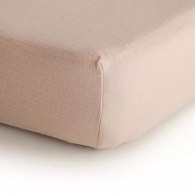 Corner of blush pink fitted sheet