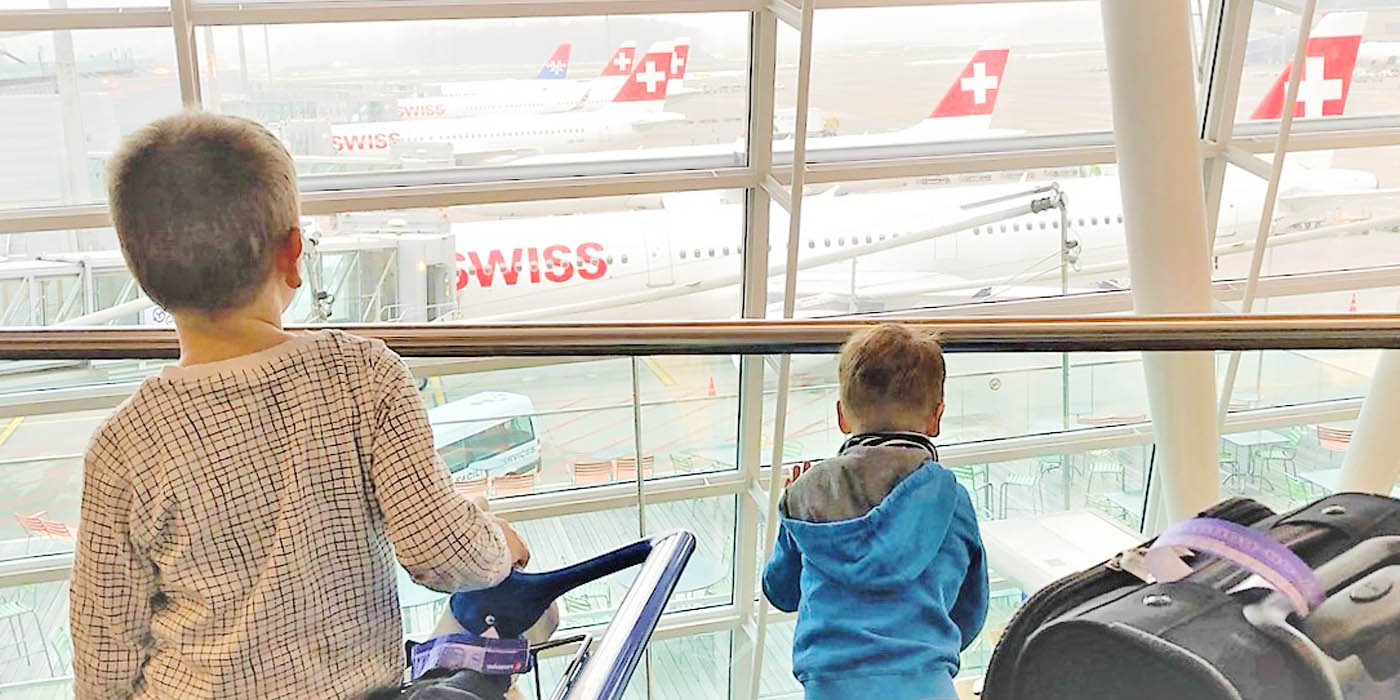 two boys looking at planes 
