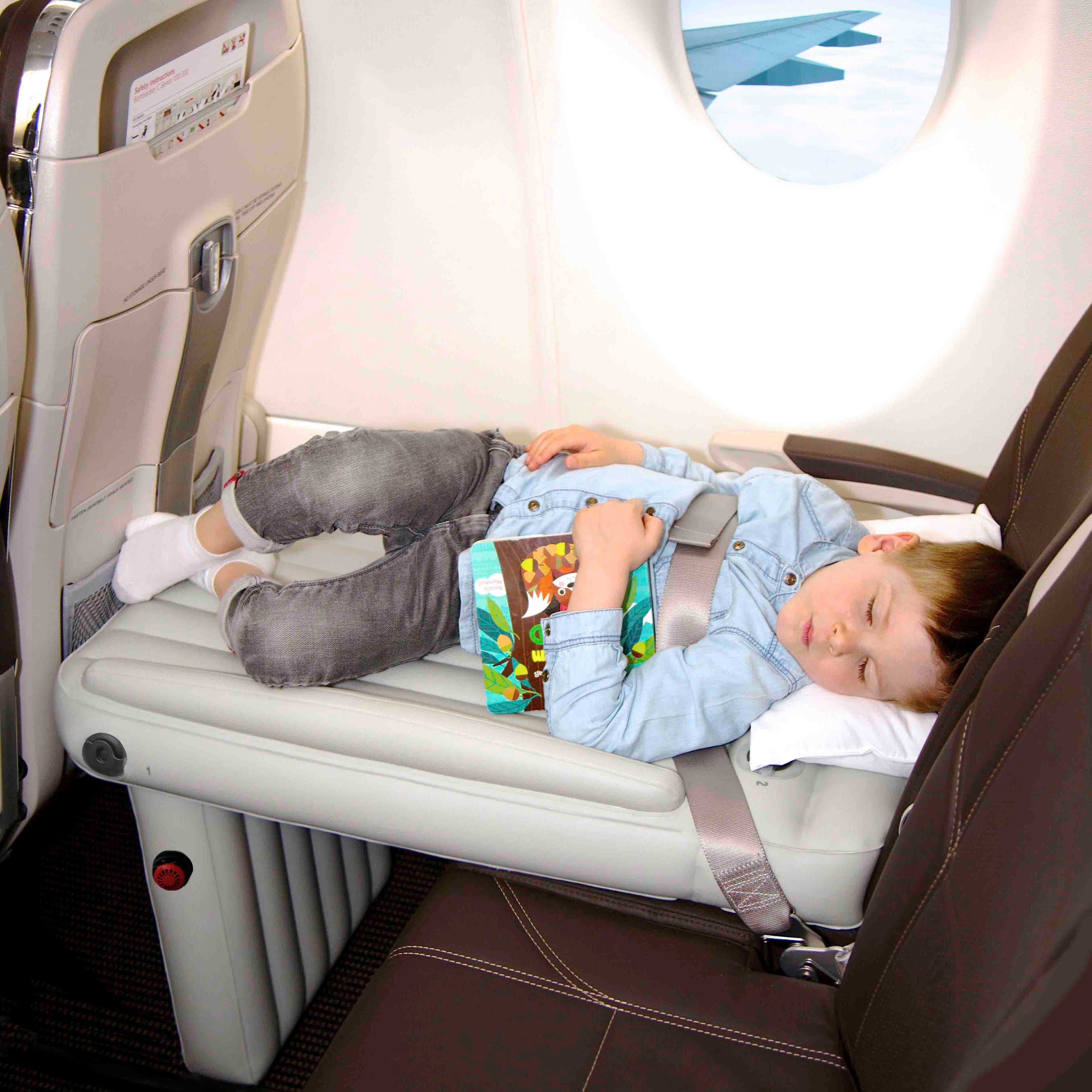 Child laying on Flyaway Kids Bed with book