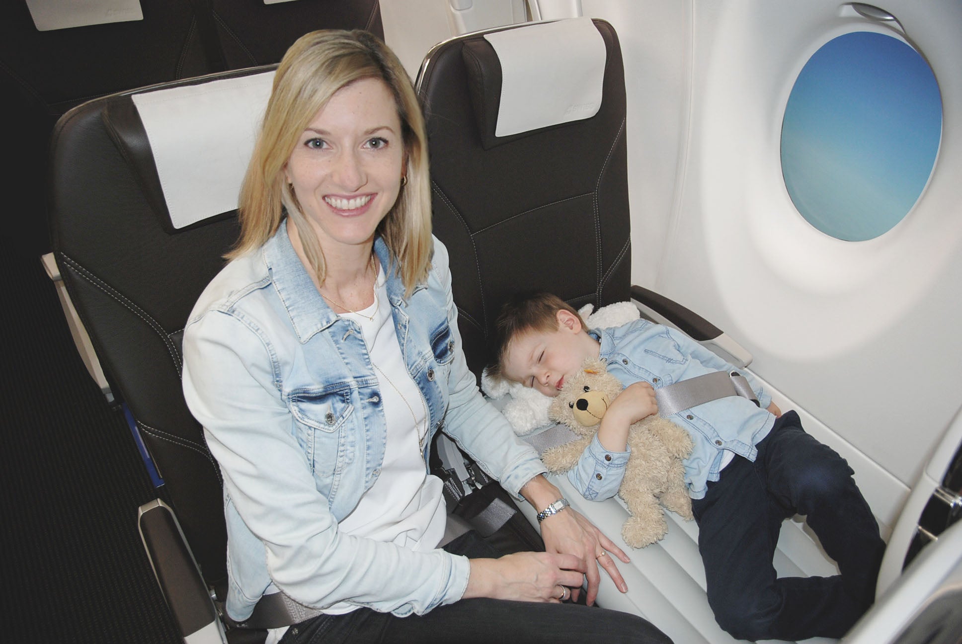 Flyaway kids bed with sleeping child in the airplane 